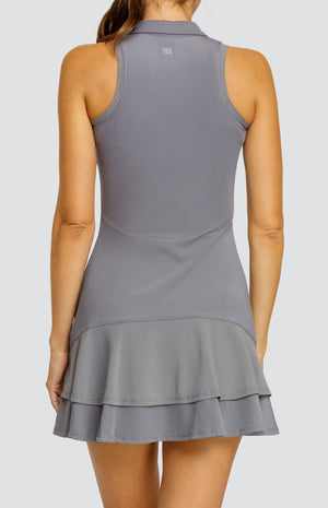 Model wearing a gray sleeveless dress with a quarter zip foldover collar and a double ruffle in the back.