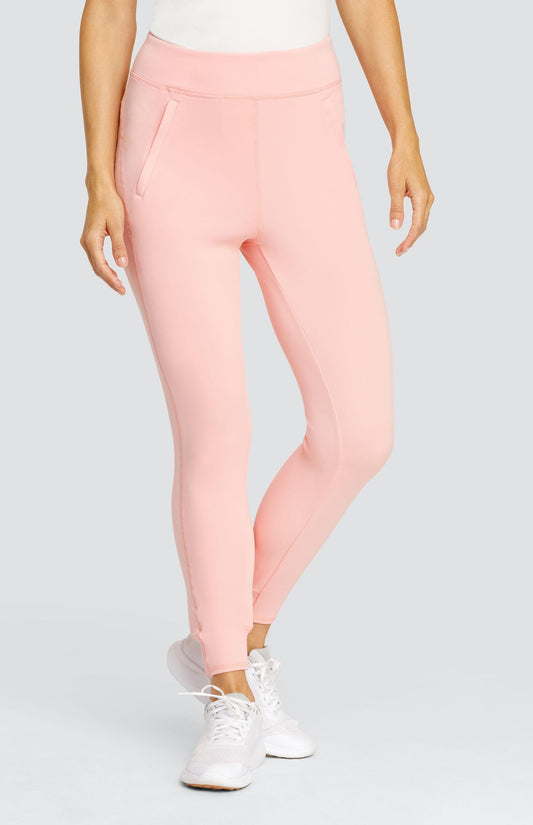 Model wearing a light pink ankle length jogger with a waistband, welt pockets, and ribbed back ankle cuffs.