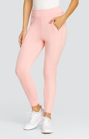 Model wearing a light pink ankle length jogger with a waistband, welt pockets, and ribbed back ankle cuffs.