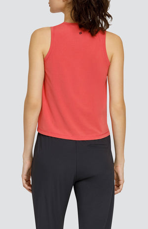 Model wearing a coral hi-low swing tank top and black joggers with elastic drawstring waistband and pockets.