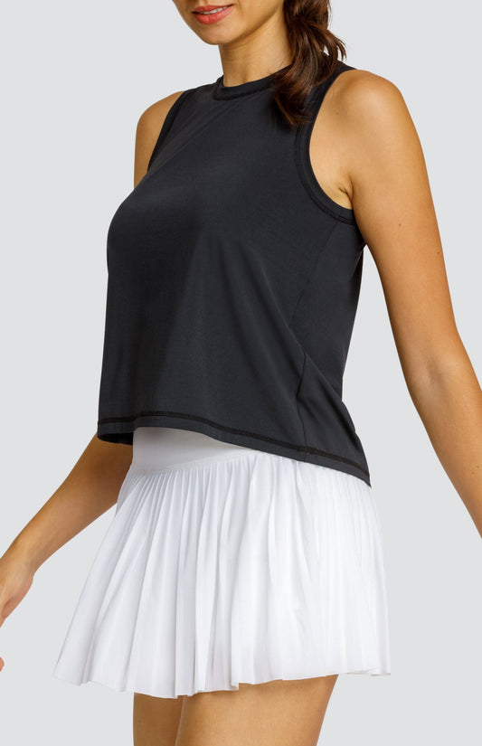 Model wearing black hi-low swing tank top and white micro pleated mesh skort.