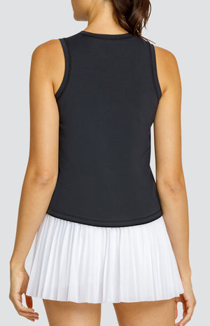 Model wearing black hi-low swing tank top and white micro pleated mesh skort.