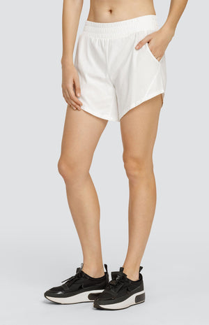 Model wearing white shorts with an elastic waistband and pockets.