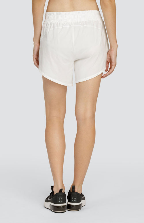 Model wearing white shorts with an elastic waistband and pockets.