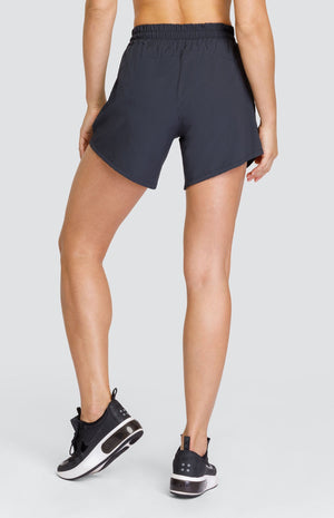 Model wearing black shorts with elastic waistband and pockets.