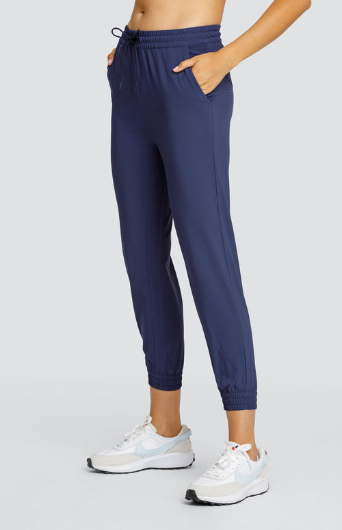 Model wearing a navy blue jogger with elastic drawstring waistband and elastic ankle cuffs.