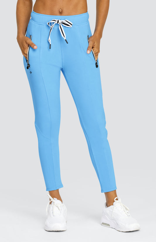 Model is wearing Ocean Blue joggers with a drawstring waist and side zipper pockets. 