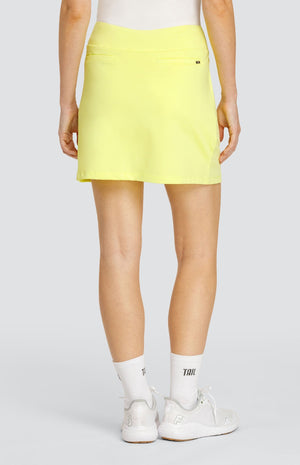 Model wearing a solid yellow pull-on golf skort.