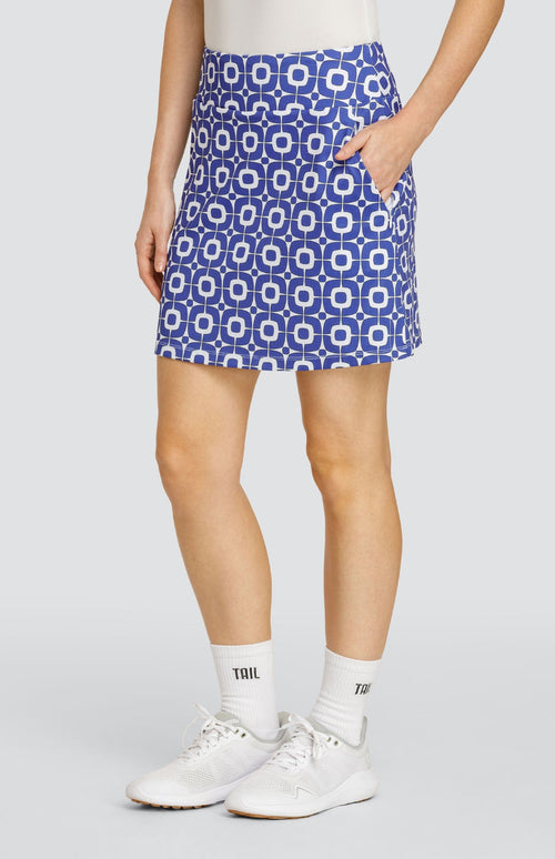 Model wearing a pull-on golf skort with a blue and white geometric pattern.