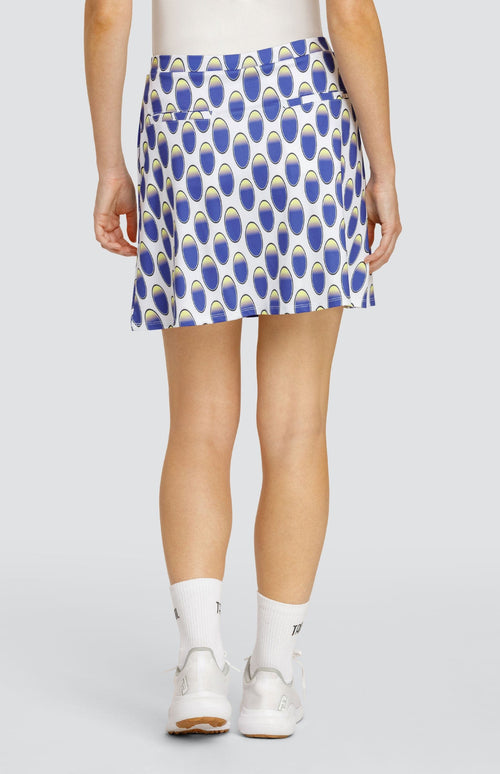 Model wearing a pull-on golf skirt with an oval pattern in blue and yellow on a white background.