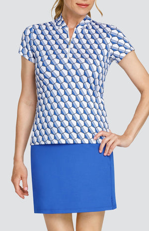 Model wearing a short sleeve top with a blue and white hexagon pattern, and a solid blue skort.