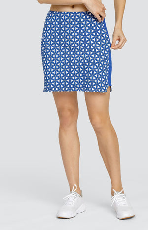 Model wearing a pull on skort with a blue and white lattice pattern with blue side inserts.