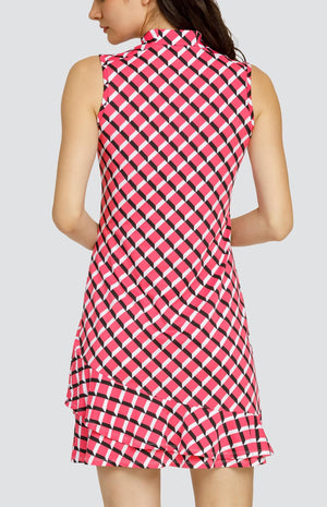 Model wearing a sleeveless quarter-zip golf dress in a pink 3-dimensional block pattern.