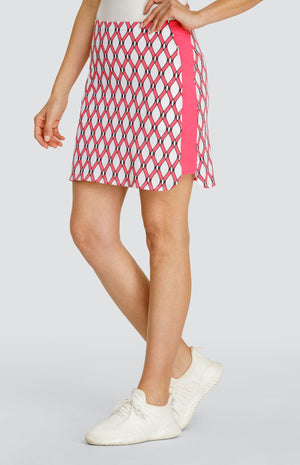 Model wearing a pull-on golf skort with a pink and white lattice pattern.