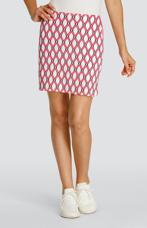 Model wearing a pull-on golf skort with a pink and white lattice pattern.