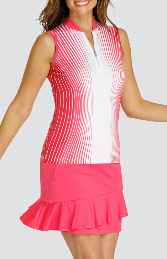 Model wearing a quarter-zip sleeveless golf top with a gradient linear pink and white pattern and a pull on pink golf skort with a flounce insert.