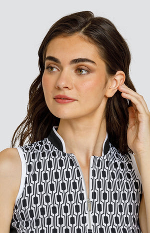 Model wearing a sleeveless golf top with a chain link style black and white print, with black side inserts.